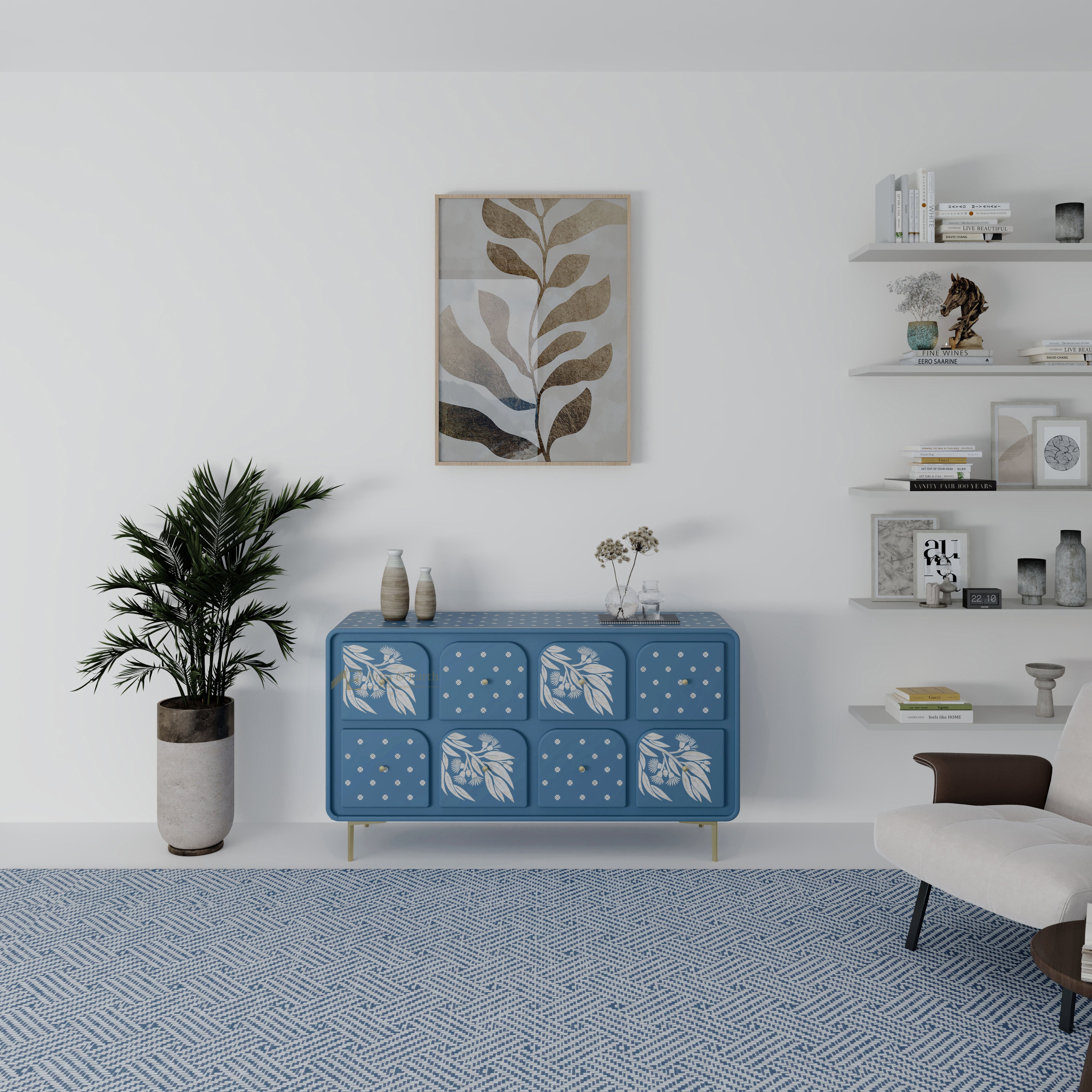 Blue chest of drawers with white floral patterns in a modern living room setting.