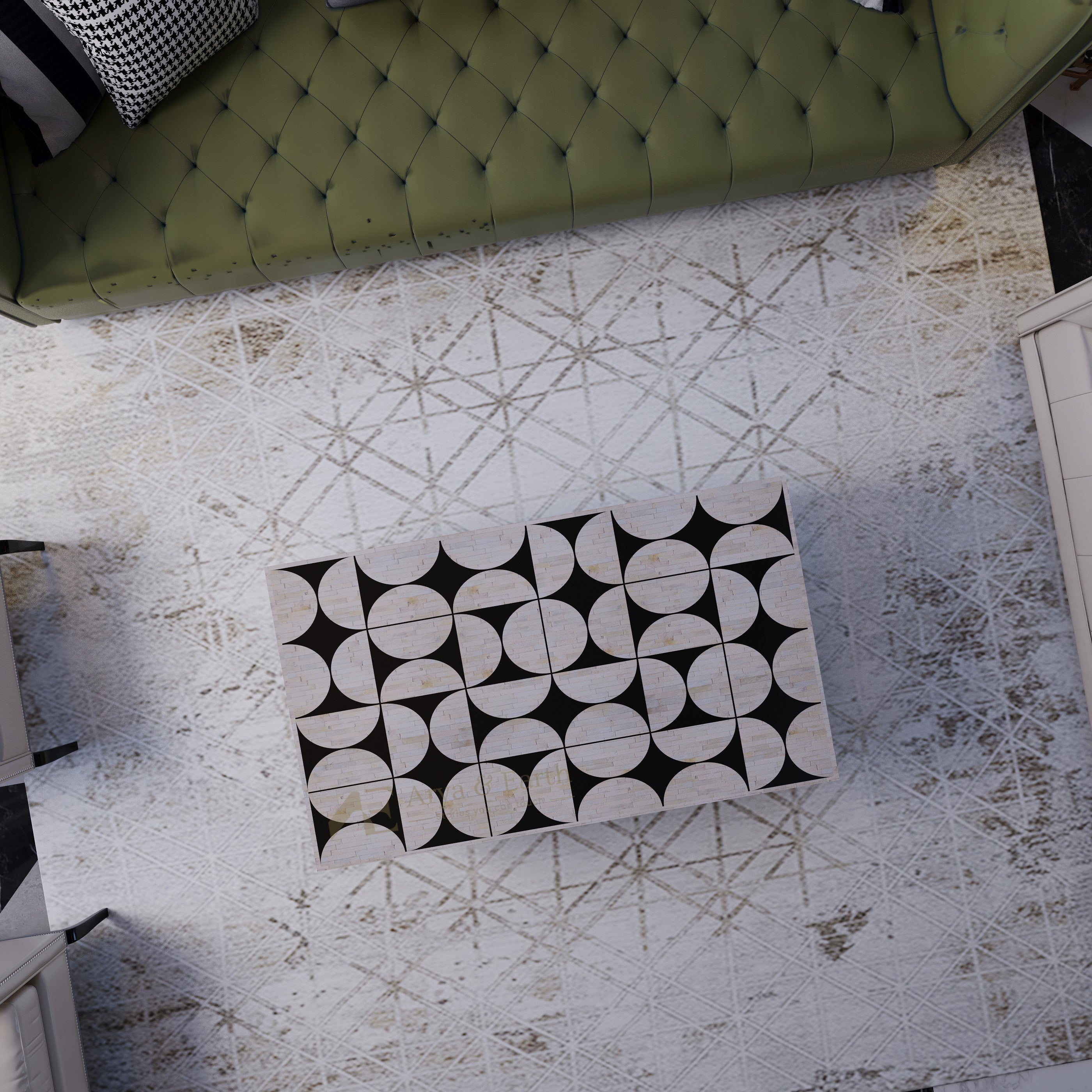 top view of Black and white patterned bone inlay coffee table on a textured rug with a green upholstered sofa