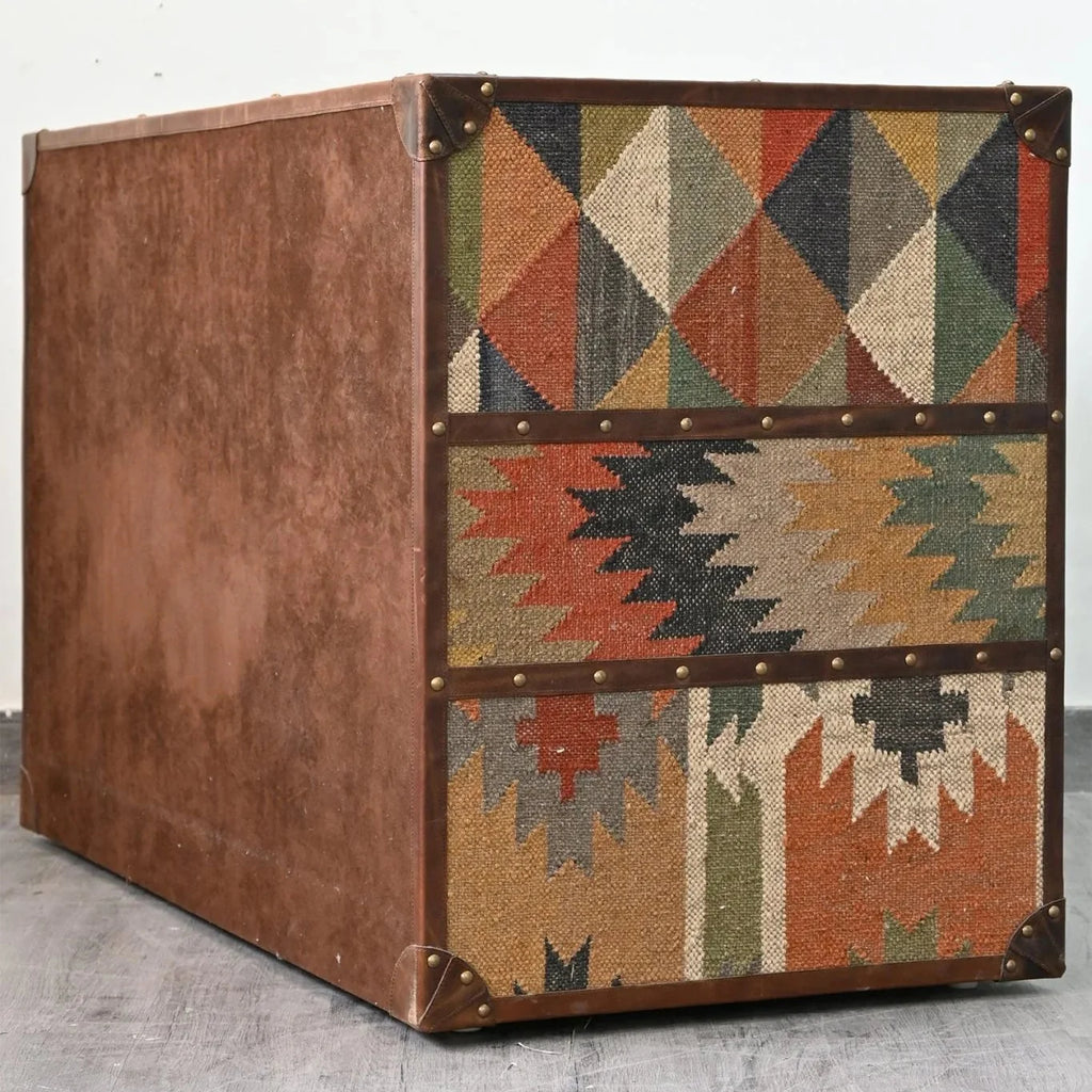 Decorative storage box with geometric pattern on a light gray floor
