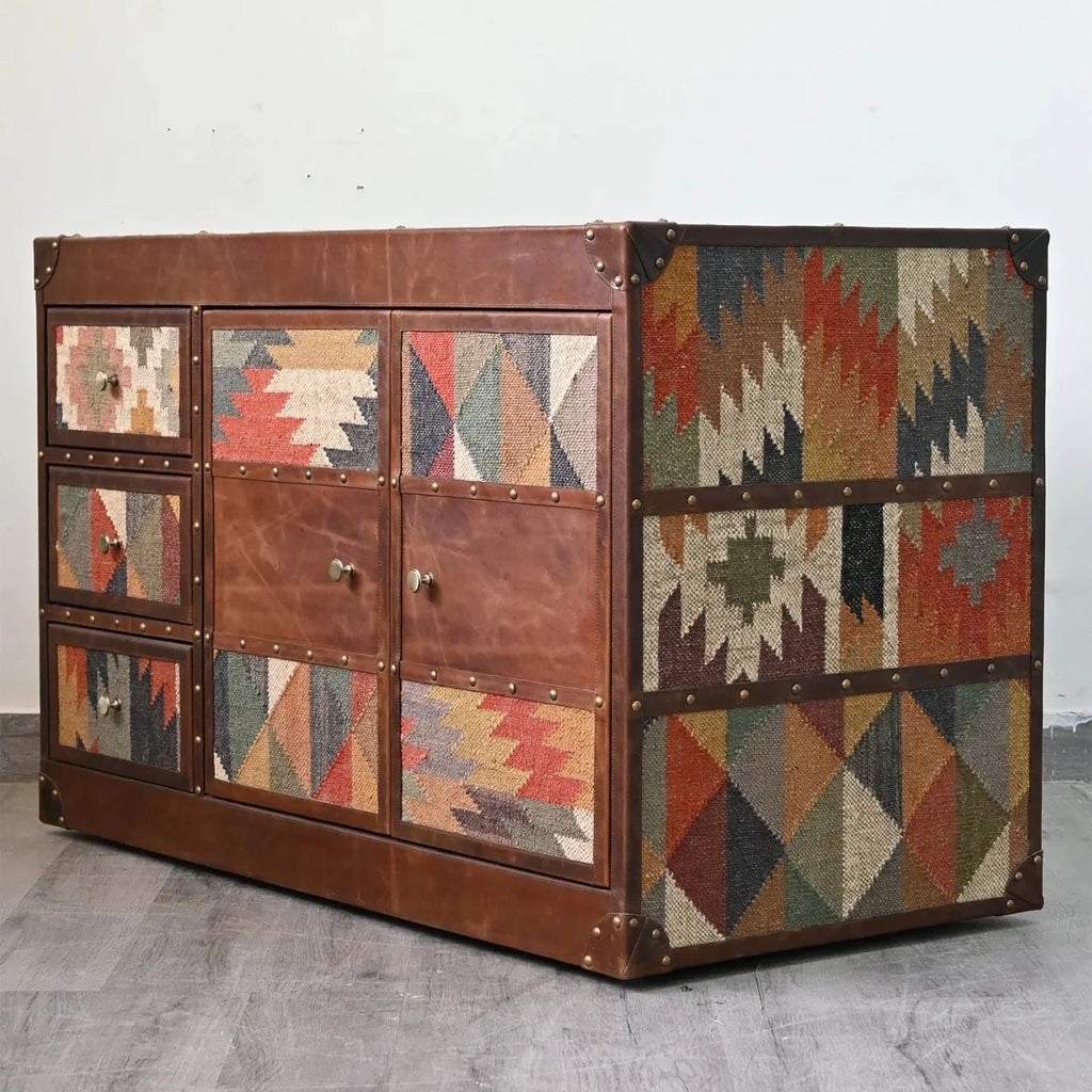 Multicolored geometric-patterned chest on a gray floor with a white wall background