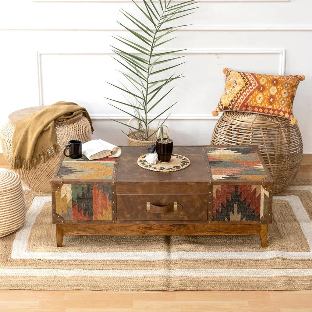 Living room with a wooden coffee table, wicker chairs, and decorative pillows.