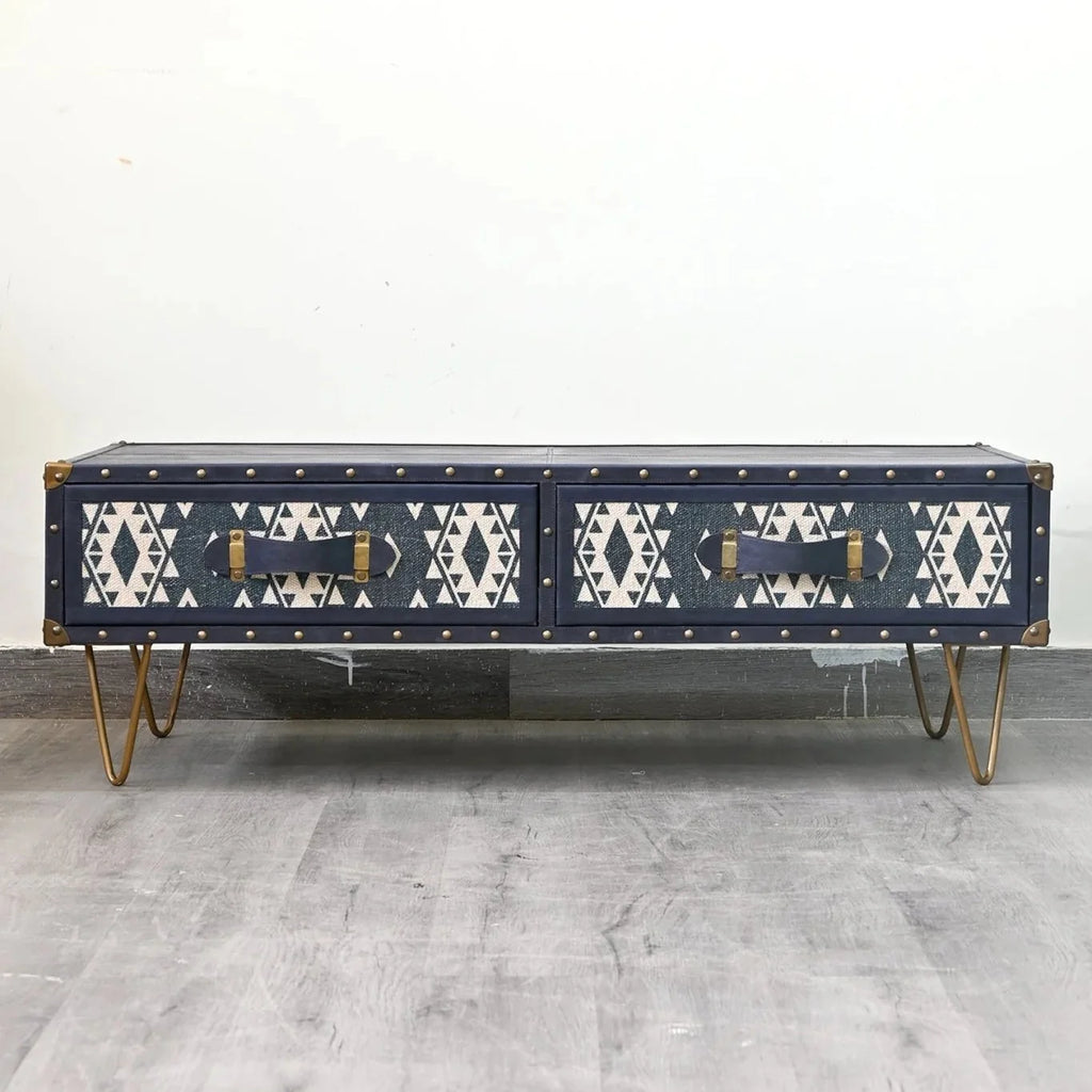 Navy blue coffee table with geometric pattern on a gray floor