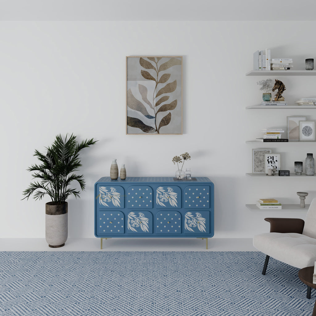 Blue chest of drawers with white floral patterns in a modern living room setting.