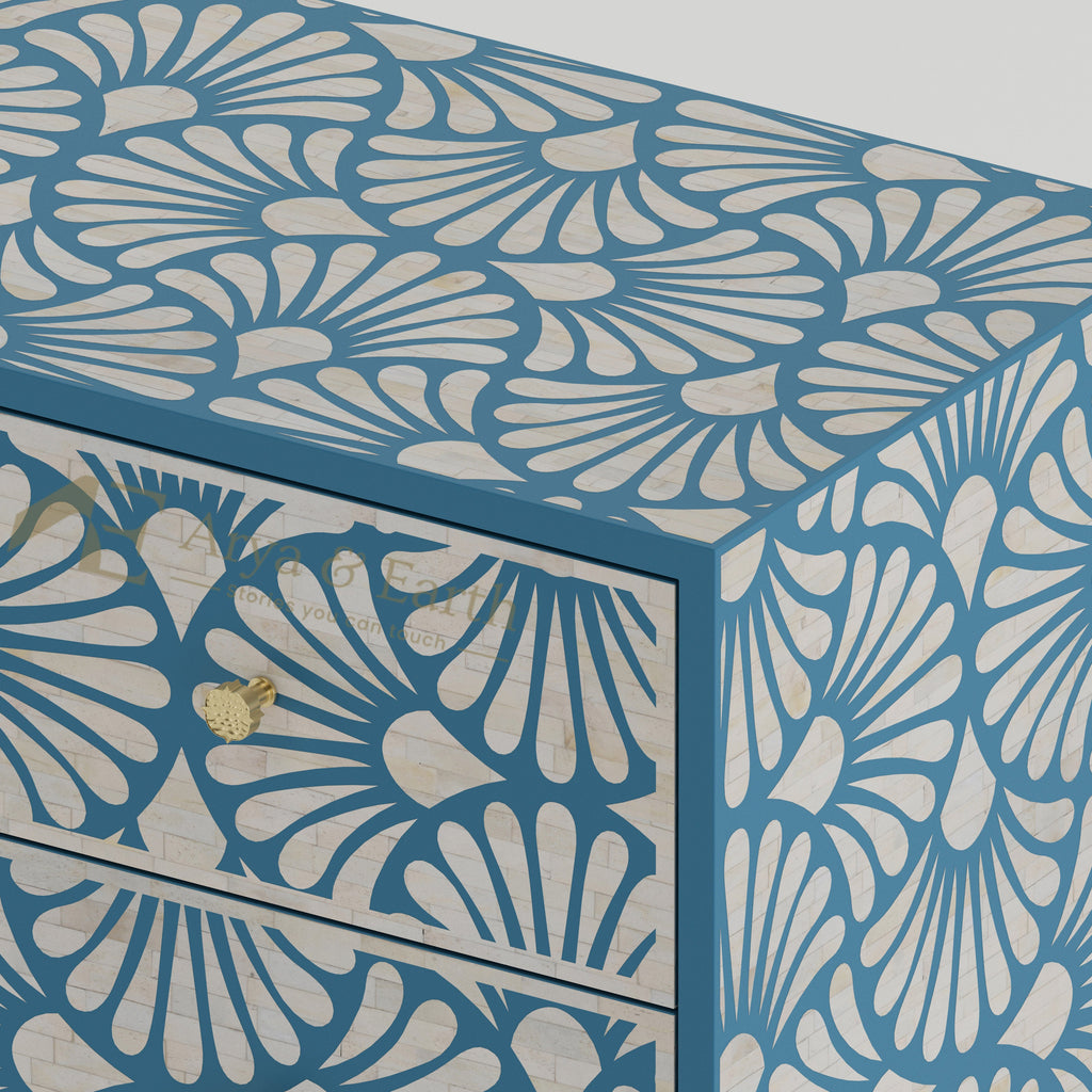 Closeup of bone inlay drawers with a blue and white floral pattern