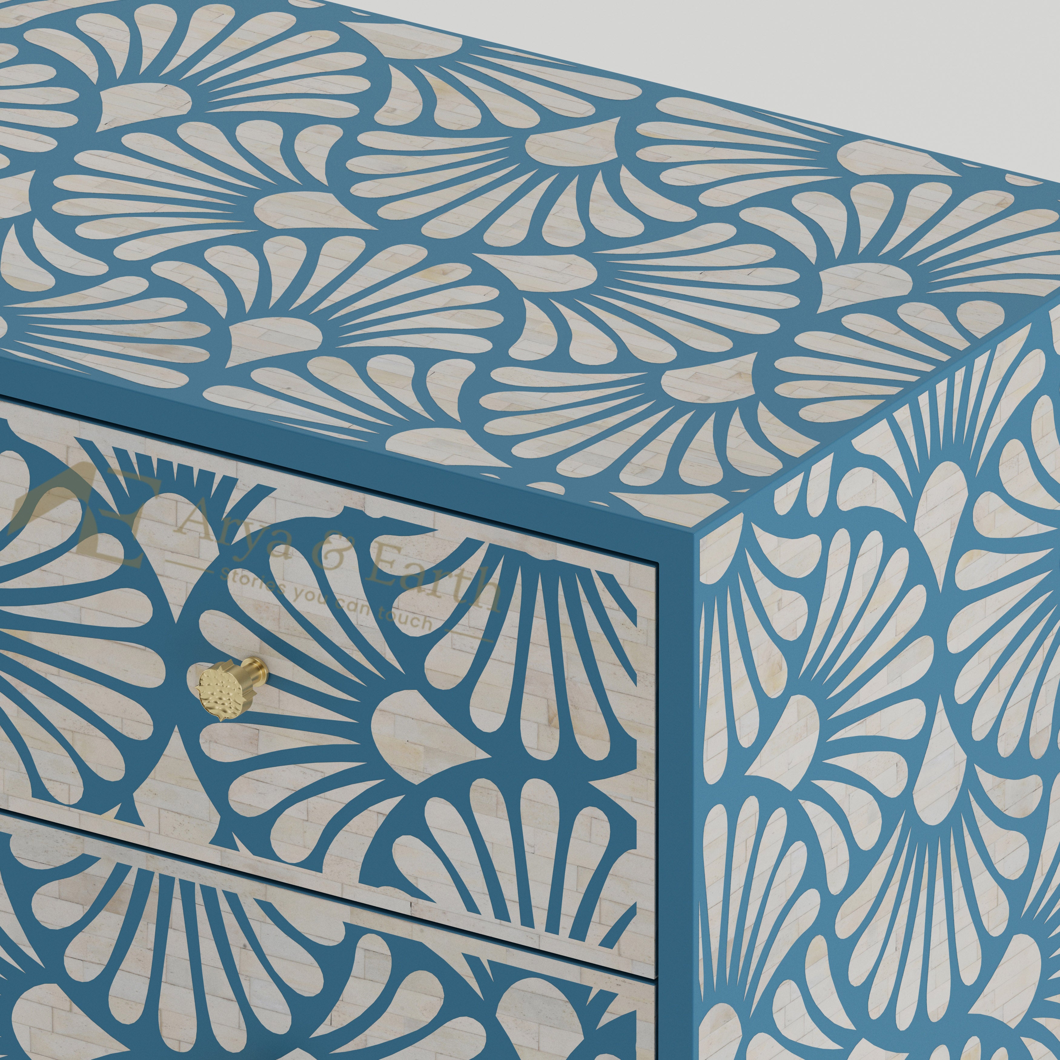 Closeup of bone inlay drawers with a blue and white floral pattern