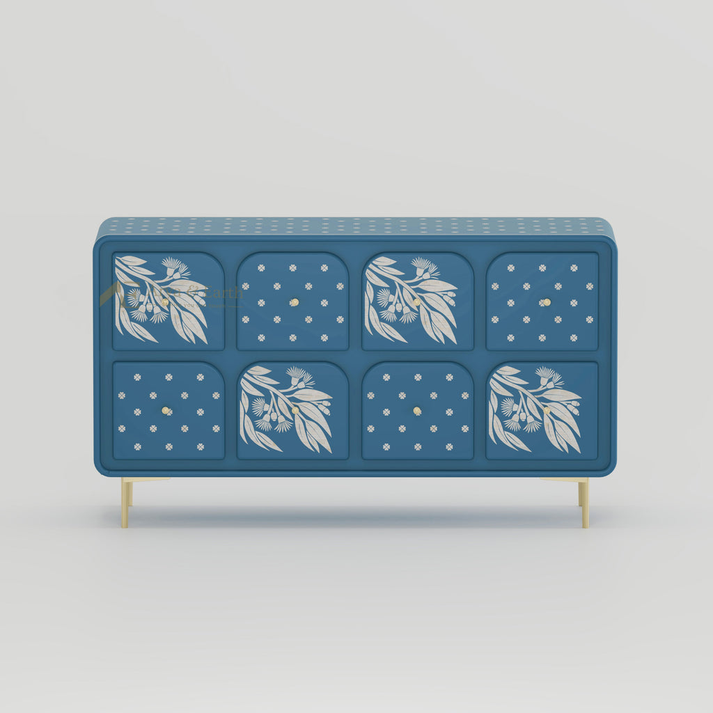 Blue sideboard with drawers with floral and geometric patterns on a light grey background