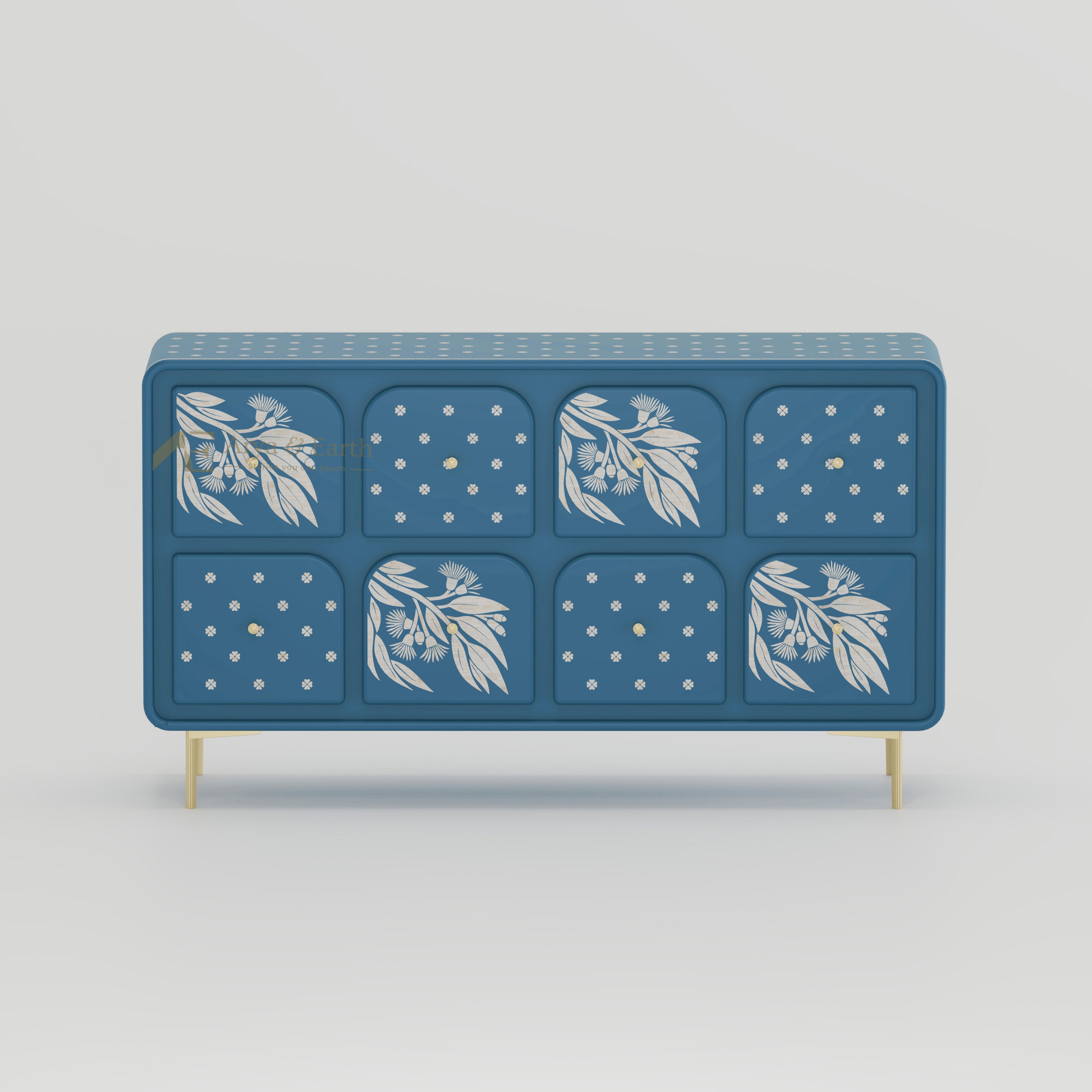 Blue sideboard with drawers with floral and geometric patterns on a light grey background