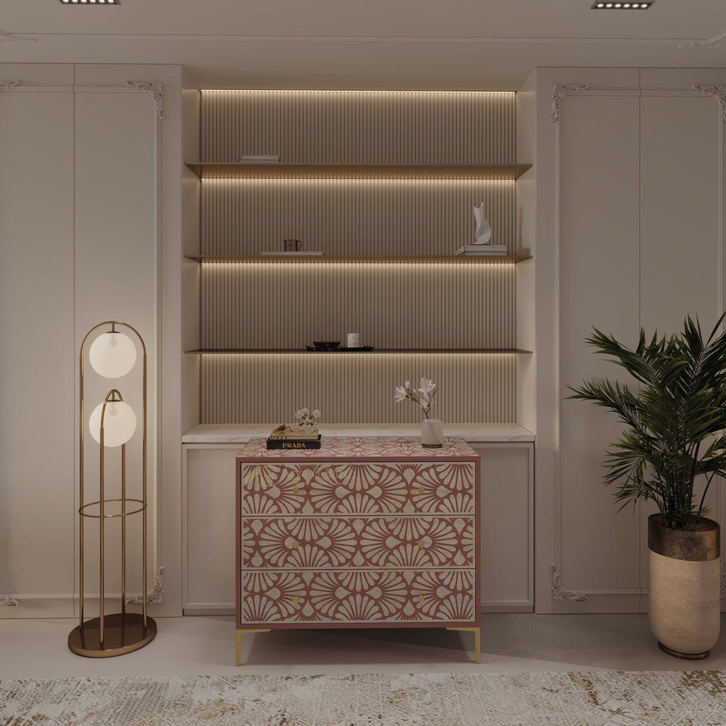 Decorative interior setting with a geometric drawer cabinet, floor lamp, and plant.