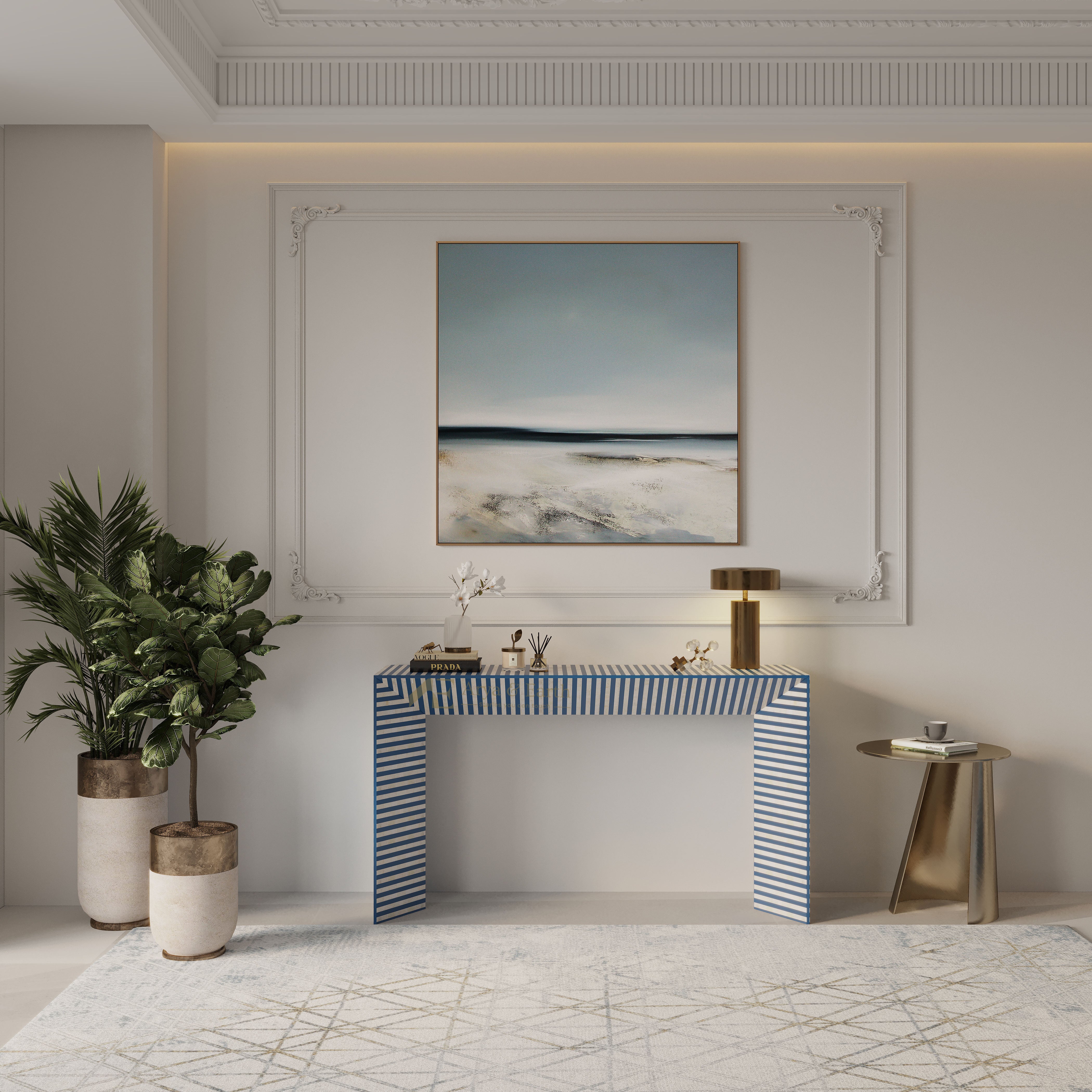 Modern interior with a striped blue console table, potted plants, and abstract painting.